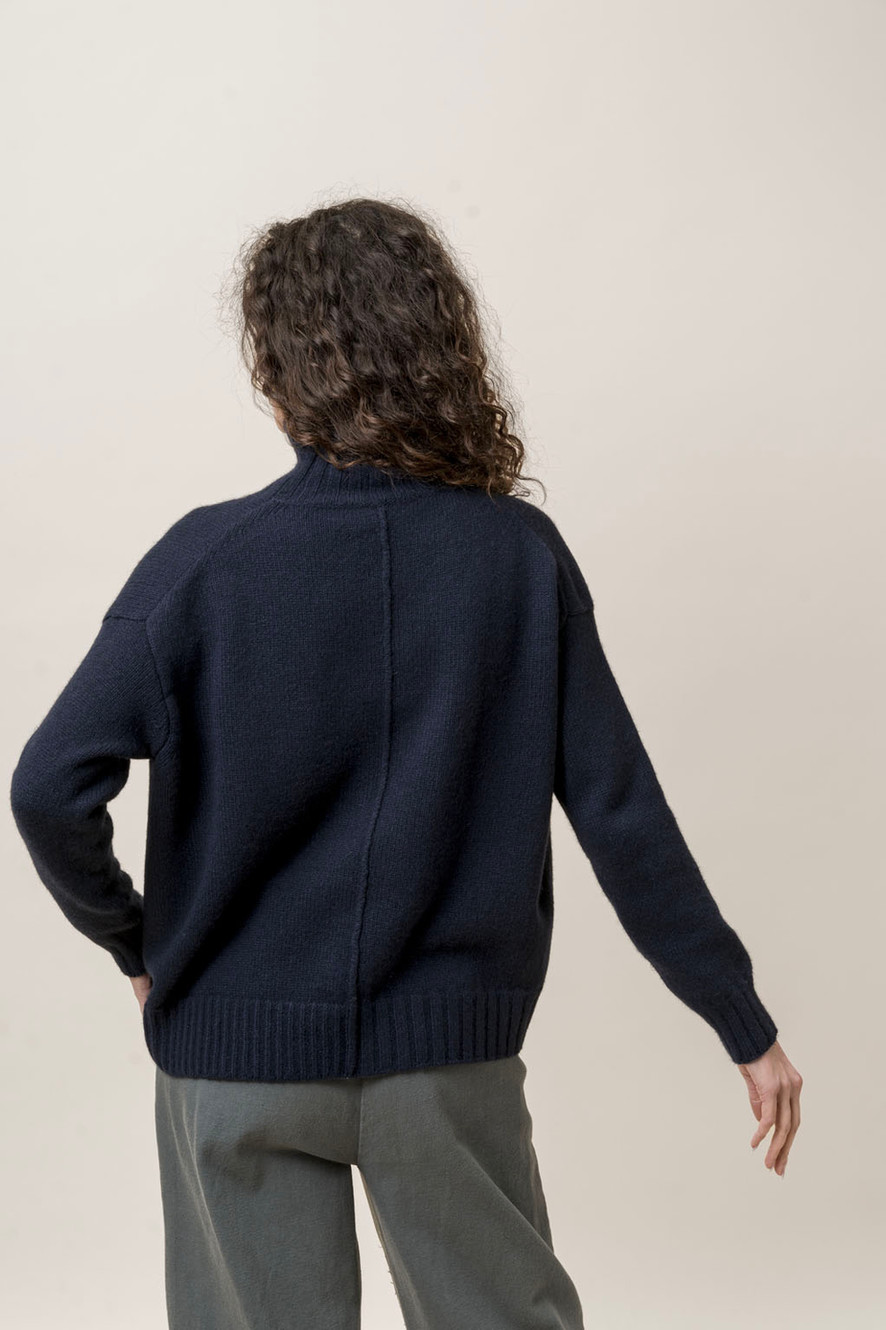 H+ Hannoh Wessel back view in a dark knit sweater