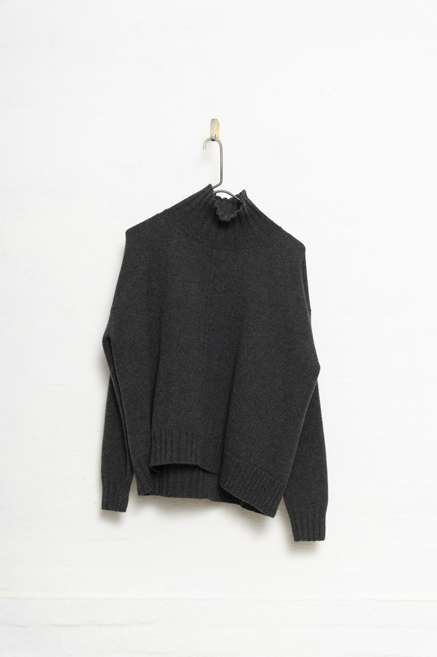 H+ Hannoh Wessel hanging black sweater on a white wall