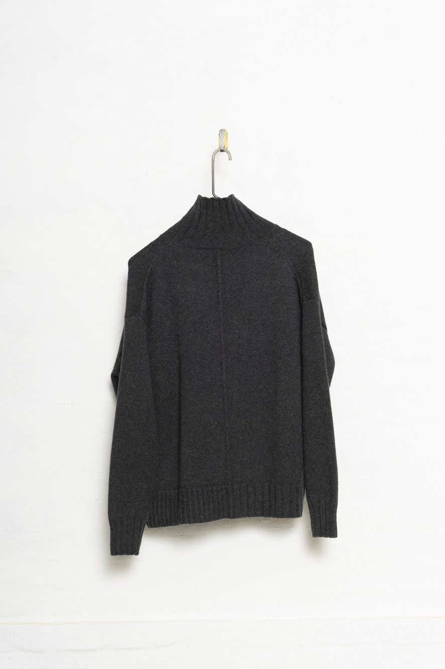 H+ Hannoh Wessel hanging neutral sweater on a white wall