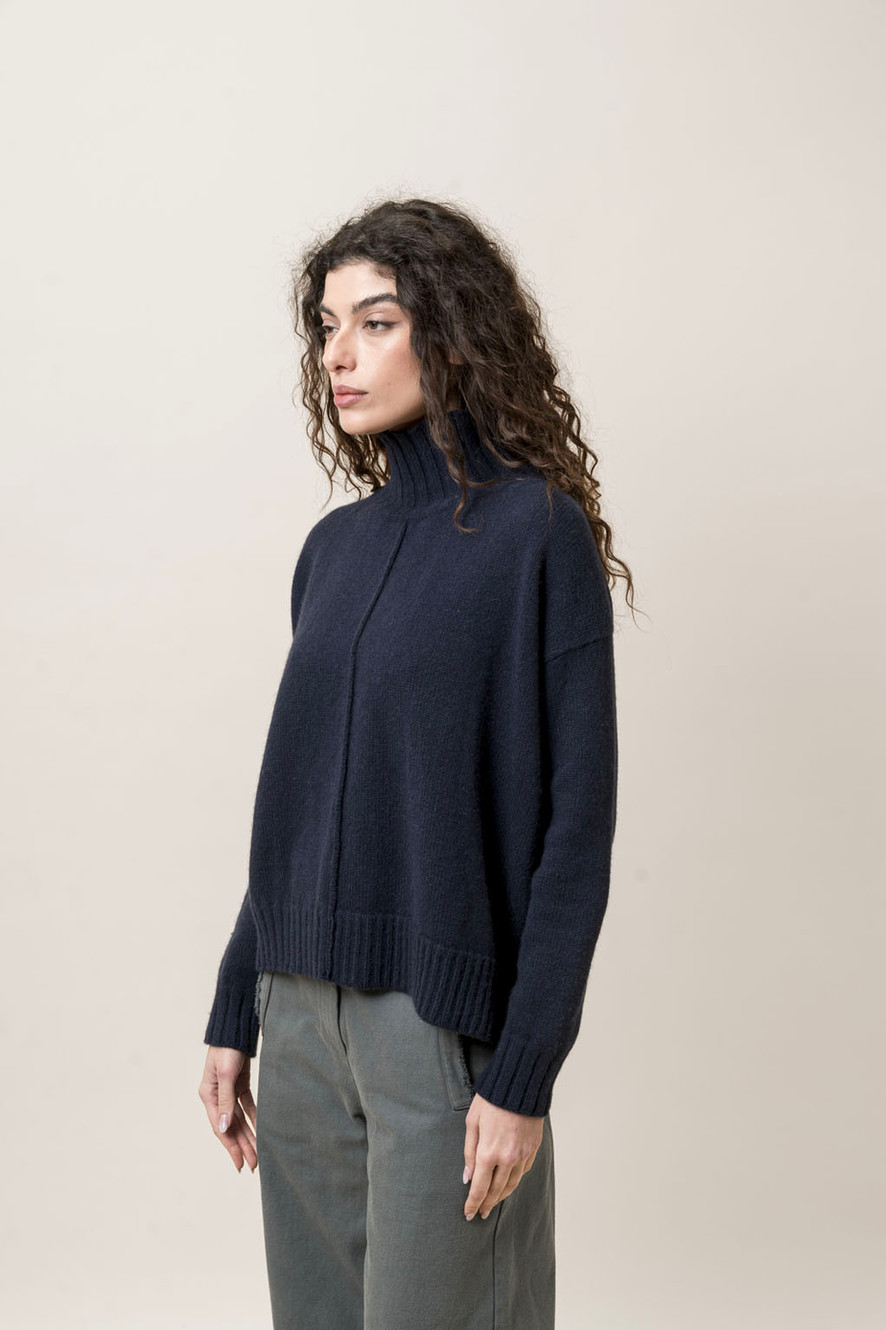 H+ Hannoh Wessel side view in a navy knit sweater