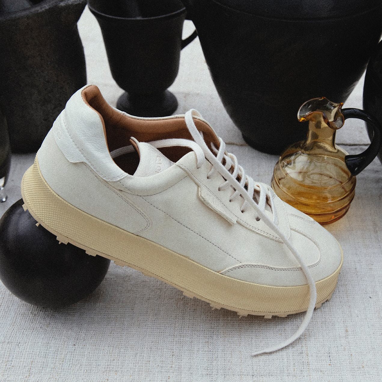 Shoto white low-top sneaker on a styled tabletop