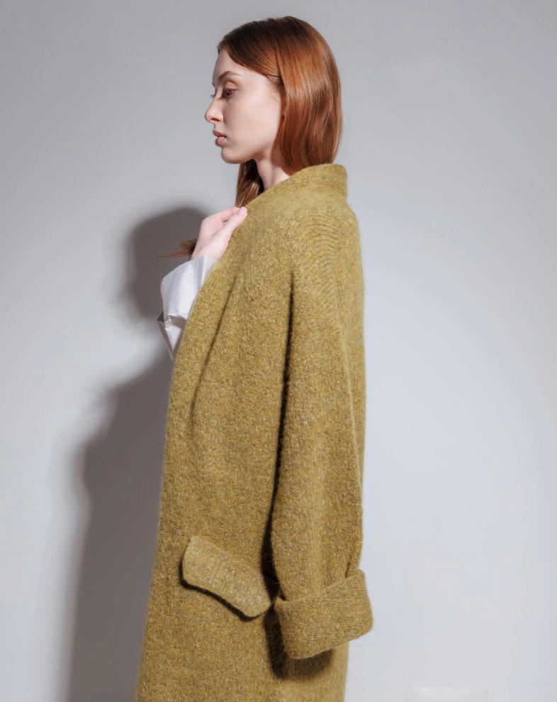 SOH close-up of an ochre knit coat