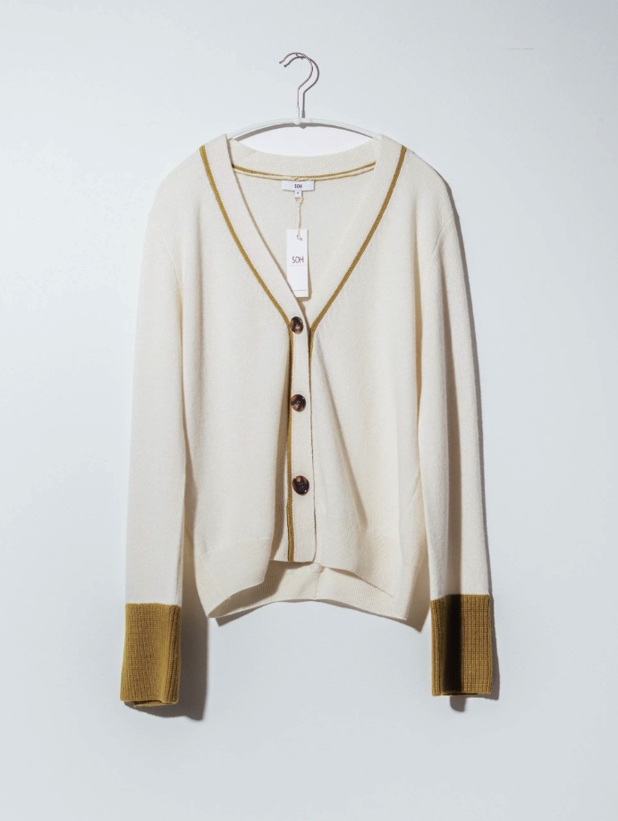 SOH cream cardigan on a hanger